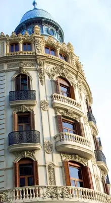 a tall building with windows and a blue dome at Poeta Llombart Apartment in Valencia