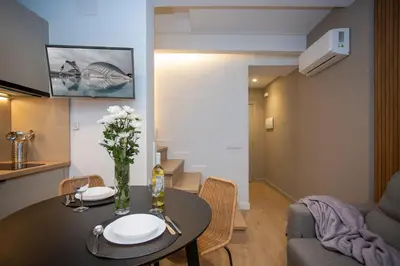 a living room with a table and a couch at Poeta Llombart Apartment in Valencia
