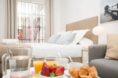 a living room with a table with fruit and juice at Poeta Llombart Apartment in Valencia