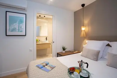 a bedroom with a bed with a bowl of fruit on a table at Poeta Llombart Apartment in Valencia