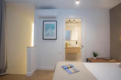 a bedroom with a bed with a picture on the wall at Poeta Llombart Apartment in Valencia