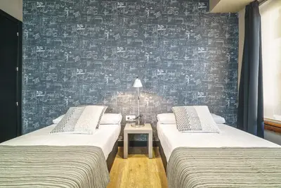 a room with two beds and a wall with graffiti at Valencia Luxury - Boutique Paz in Valencia