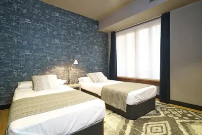 a hotel room with two beds and a window at Valencia Luxury - Boutique Paz in Valencia