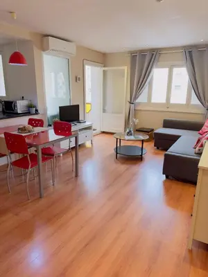 a living room with a table and a couch at Apartamento Alameda in Valencia