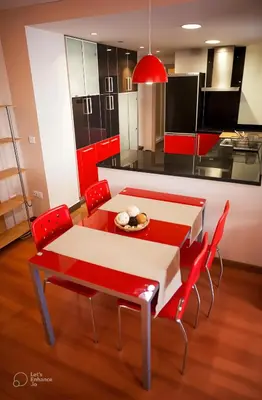 a red and white kitchen with a table and chairs at Apartamento Alameda in Valencia