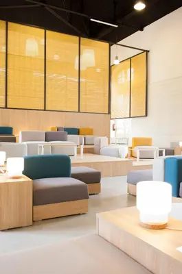 a waiting room with couches and tables at UP Hostel Valencia in Valencia
