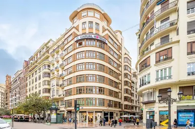 a tall building with people walking in front of it at Casual Vintage Valencia in Valencia