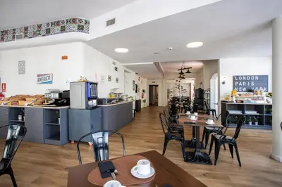 a restaurant with tables and chairs and a counter at Casual Vintage Valencia in Valencia