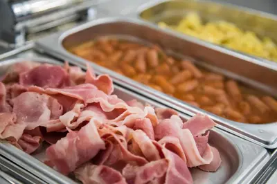 a pile of meat and other food items in trays at Casual Vintage Valencia in Valencia
