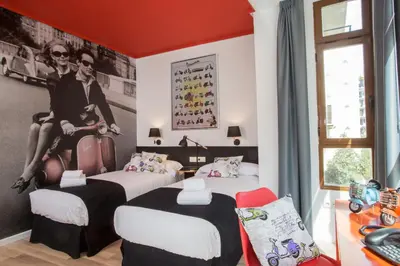 two beds in a room with red walls at Casual Vintage Valencia in Valencia