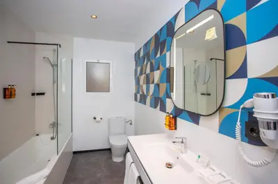 a bathroom with a sink and a mirror and a toilet at Casual Vintage Valencia in Valencia