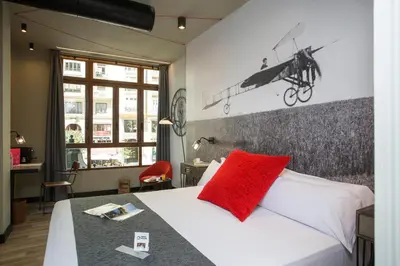 a bedroom with a bed with a red pillow on it at Casual Vintage Valencia in Valencia