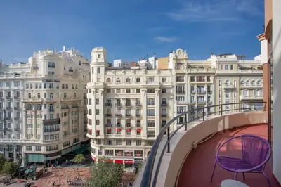 a purple chair on a balcony in front of buildings at Casual Vintage Valencia in Valencia