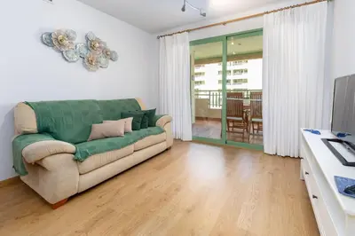a living room with a couch and a table at ApartUP Patacona Beach I in Valencia