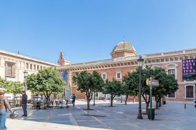 a large brick building with trees in front of it at Travel Habitat Teatro Principal in Valencia