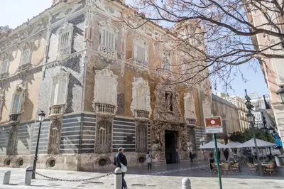 a man standing in front of a large building at Travel Habitat Teatro Principal in Valencia