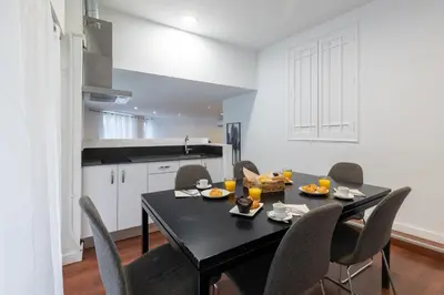 a dining room with a black table and chairs at Travel Habitat Teatro Principal in Valencia