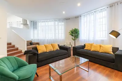 a living room with two couches and a glass table at Travel Habitat Teatro Principal in Valencia