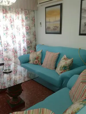 a blue couch with pillows in a living room at Apartamento PuigVal in El Puig