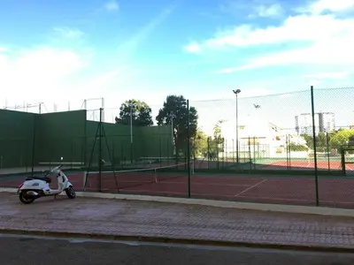 a scooter parked on a tennis court at Apartamento PuigVal in El Puig
