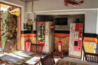 a restaurant with two tables and chairs and a tv at Hotel Iris La Eliana in La Eliana