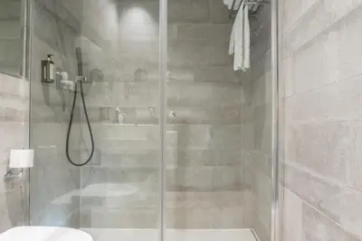 a shower with a glass door in a bathroom at The Valentia Cabillers in Valencia