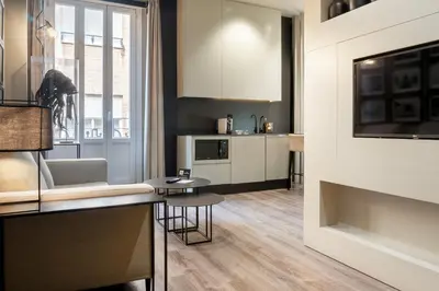 a kitchen with white cabinets and a table at The Valentia Cabillers in Valencia