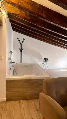 a large bath tub in a room with a couch at Hotel El Siglo in Valencia