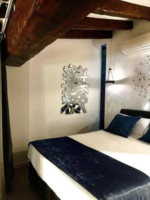 a bedroom with a bed and a painting on the wall at Hotel El Siglo in Valencia