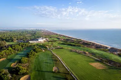 an aerial view of a golf course next to the ocean at Parador de El Saler in El Saler