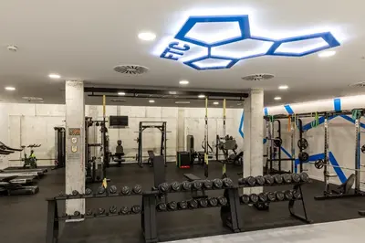a gym with dumbbells and a blue ceiling at Parador de El Saler in El Saler