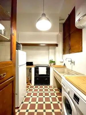 a kitchen with a checkered floor and a refrigerator at Victoria Site-Luxury Center in Valencia