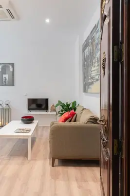 a living room with a couch and a table at Victoria Site-Luxury Center in Valencia