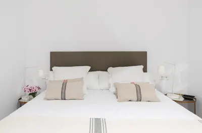 a white bed with white sheets and pillows at Victoria Site-Luxury Center in Valencia