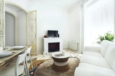 a living room with a white couch and a fireplace at Victoria Site-Luxury Center in Valencia