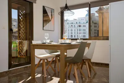 a dining room with a table and chairs and a window at Xativa Terrace II in Valencia