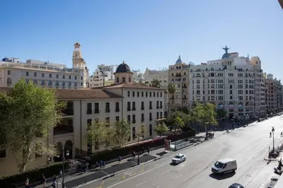 a city street with buildings and cars on the road at Xativa Terrace II in Valencia