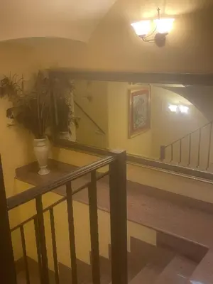 a staircase with a plant in a vase on a table at La Posá in Villar del Arzobispo