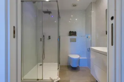 a bathroom with a shower and a toilet and a sink at Salamar Saler Golf in El Saler