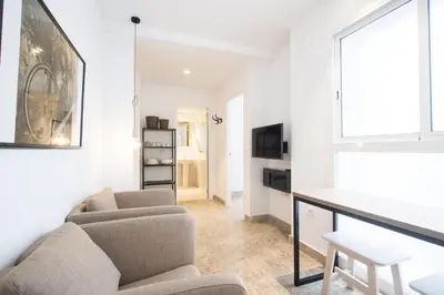 a living room with a couch and a table at Apartamentos Marina Playa in Valencia