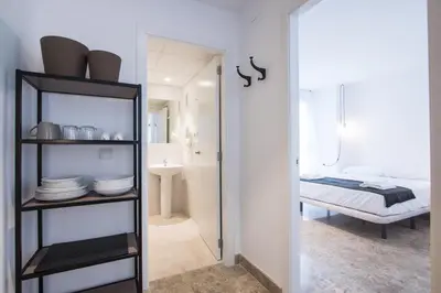 a room with a bathroom and a bedroom at Apartamentos Marina Playa in Valencia