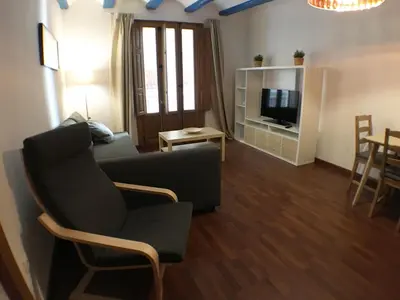 a living room with a couch and a tv at Living Valencia Peydro in Valencia
