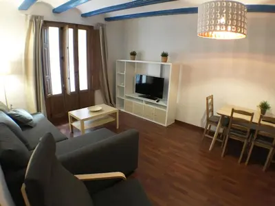 a living room with a couch and a tv and a table at Living Valencia Peydro in Valencia