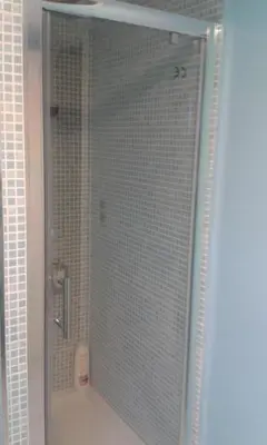 a shower with a glass door in a bathroom at Sweet Caroline Apartment in Valencia