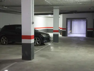 a parking garage with a car parked in it at Flats Friends Soho Suites in Valencia