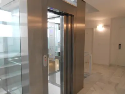 an elevator in a building with a glass door at Flats Friends Soho Suites in Valencia