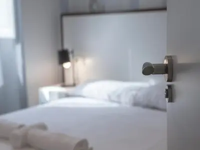 a bedroom with a white bed and a mirror at Flats Friends Soho Suites in Valencia
