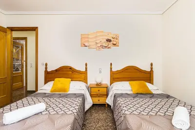 two beds in a room with two beds sidx sidx sidx at MoYma Playa in Puerto de Sagunto