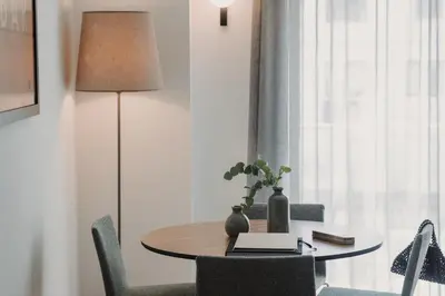 a dining room table with chairs and a lamp at Parker The Urban Flats in Valencia