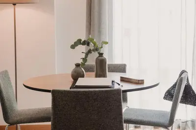a dining room table with chairs and a laptop on it at Parker The Urban Flats in Valencia